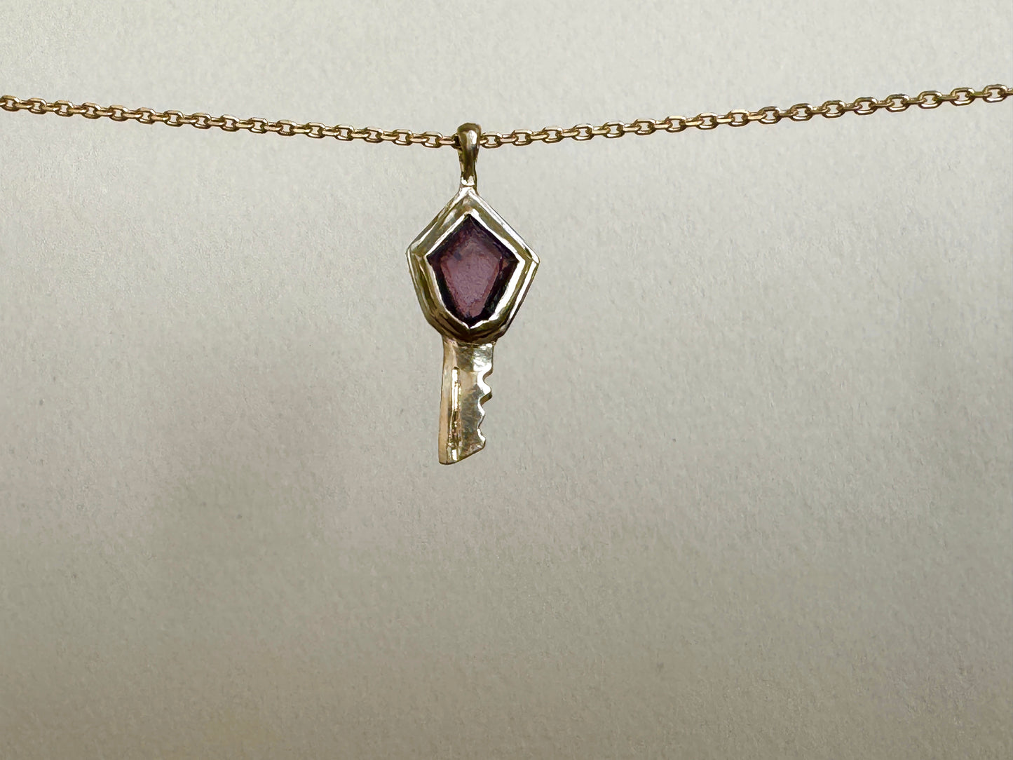 Key pendant: purple spinel shield