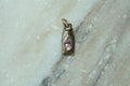 Nectar bottle charm: padparadscha sapphire