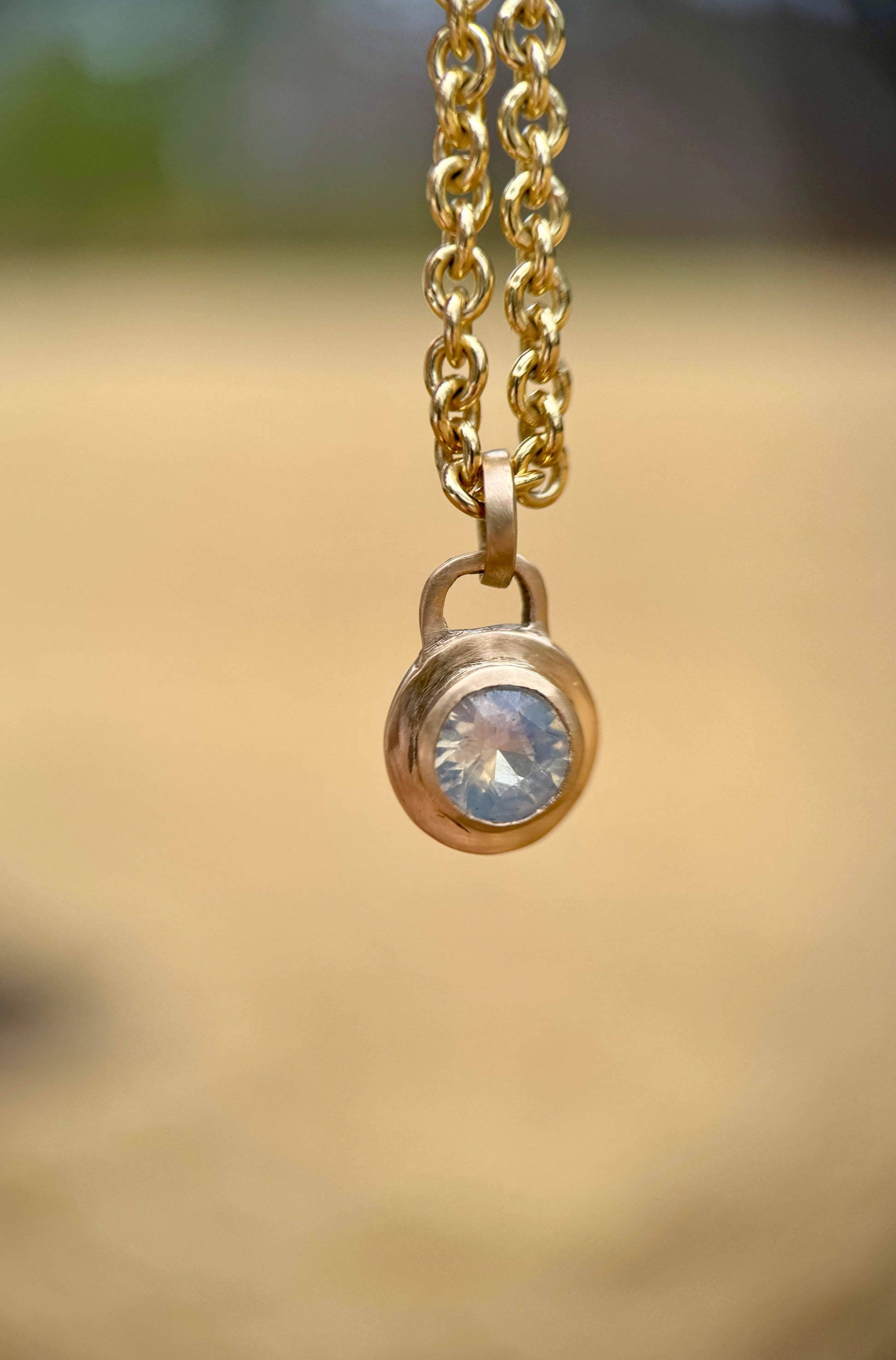 Icy blue sapphire lock pendant