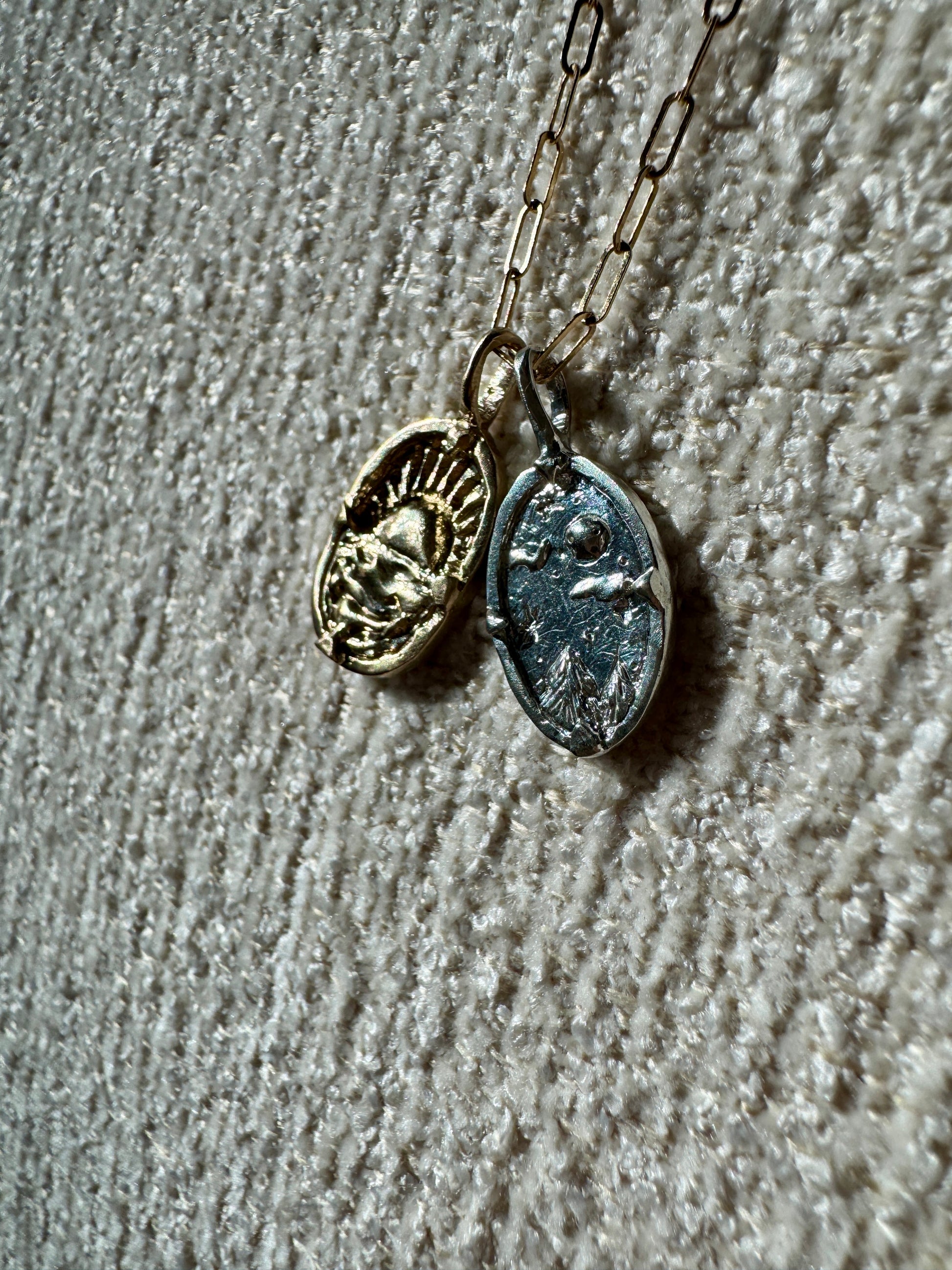 Gold and silver charms by Mellis fine jewelry