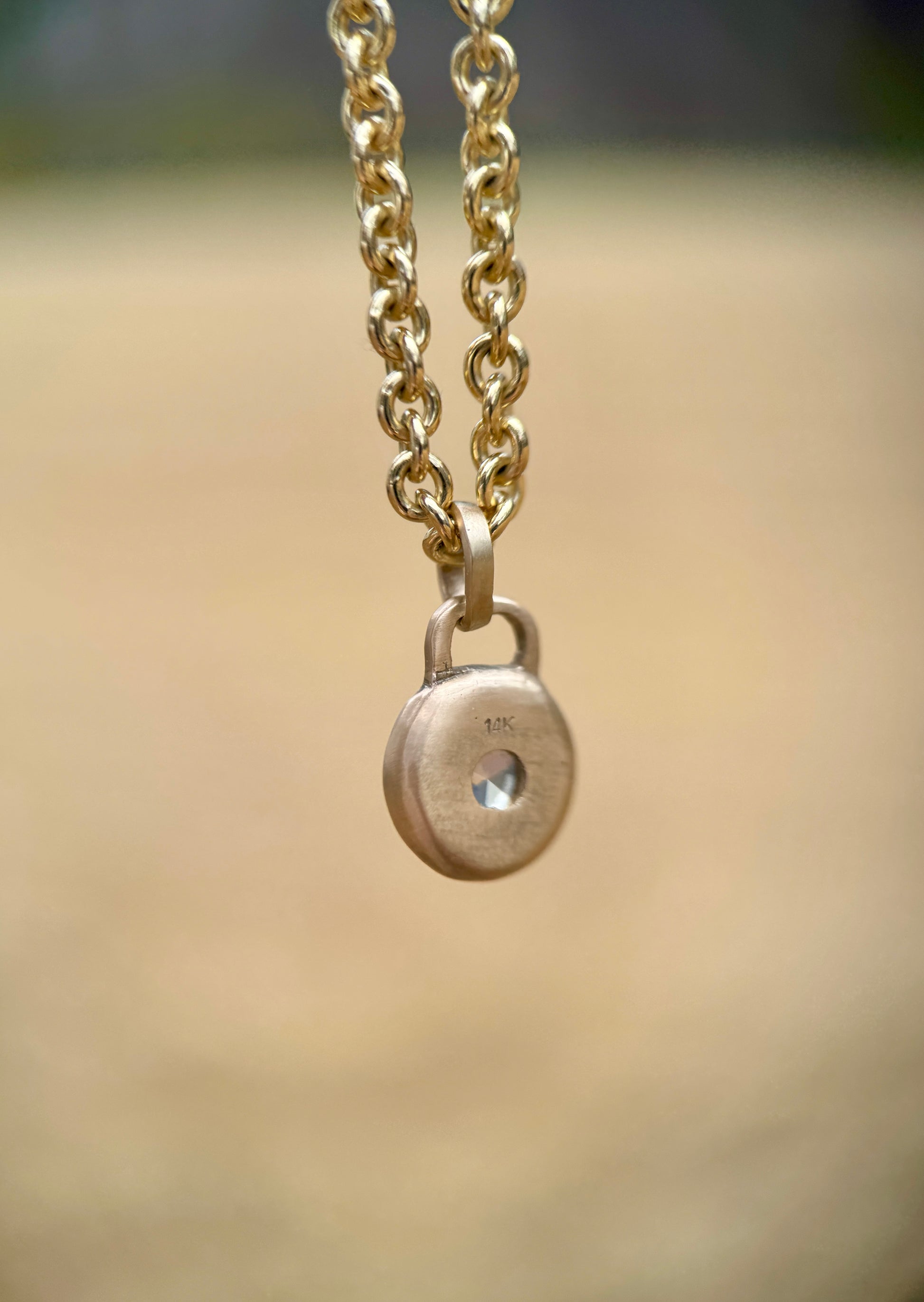 Icy blue sapphire lock pendant