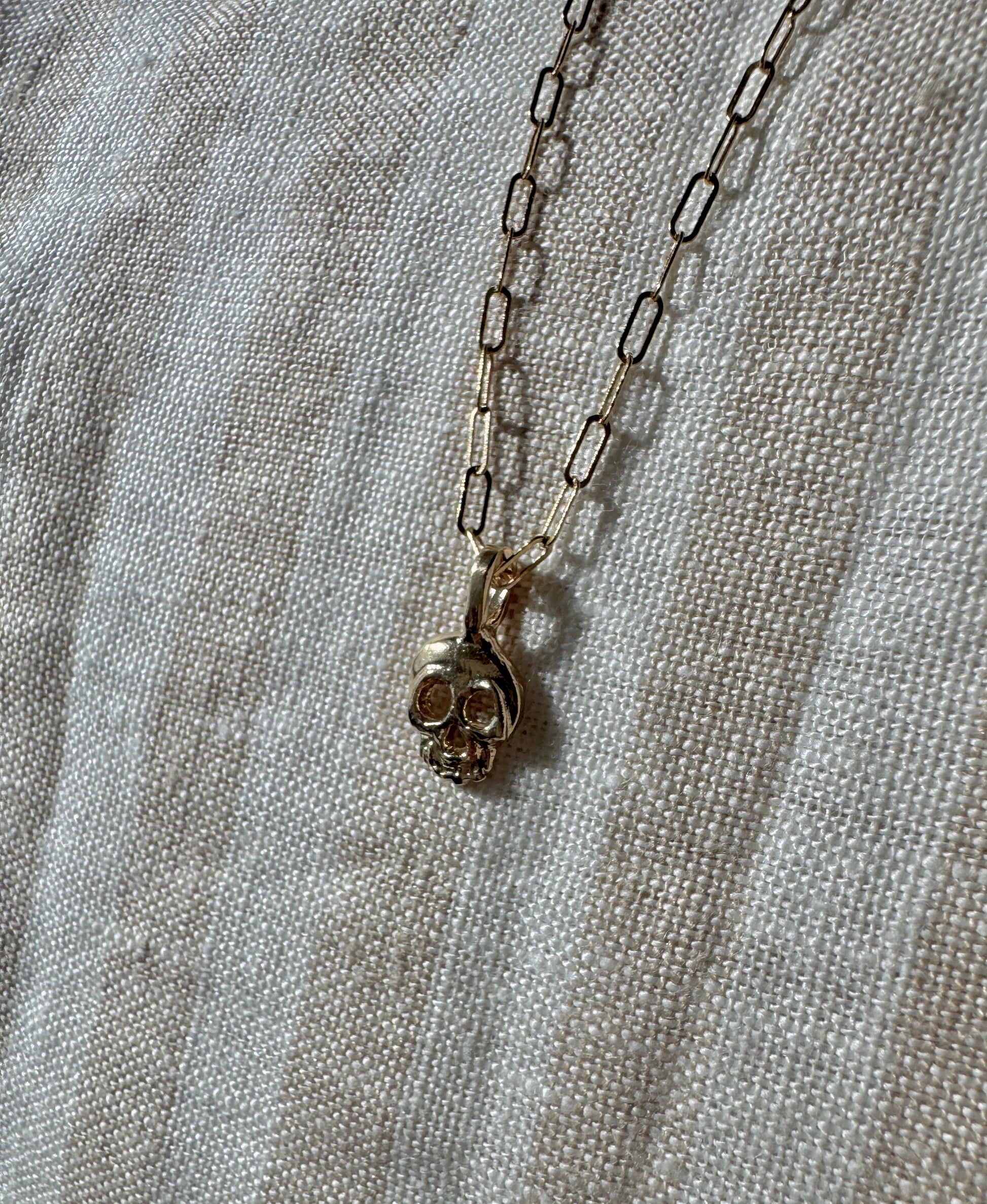 Little skull pendant in 14k gold by Mellis Fine